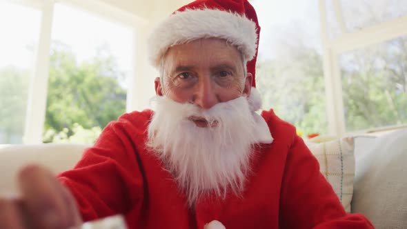 Portrait of senior caucasian man at christmas time  wearing santa costume