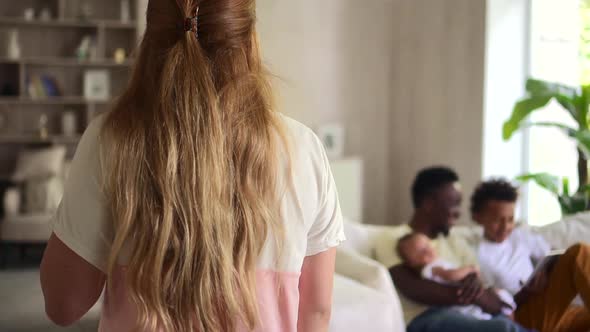 Multiethnic Family with Children Using Tablet and Sitting on Sofa in Apartment Interior Spbd