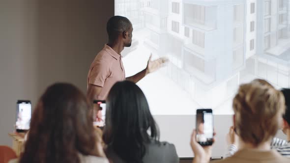 African American Speaker Talking to Audience on Architecture Conference