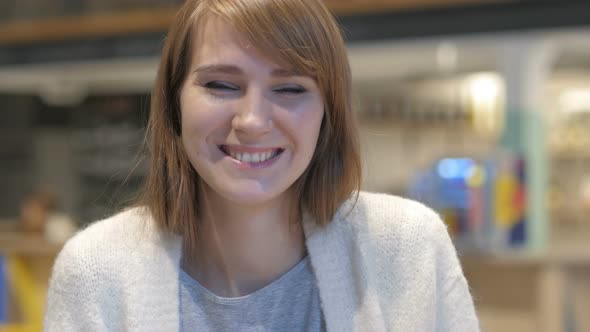 Portrait of Young Woman Inviting Customers in Cafe