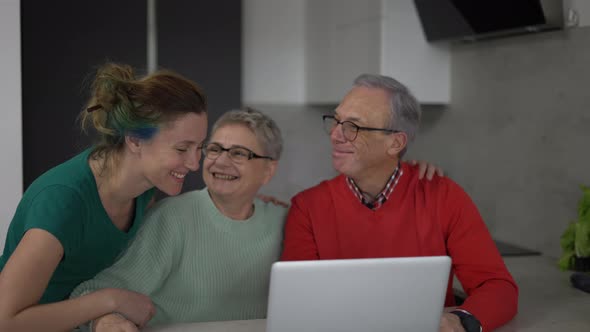 Daughter and Senior Parents Together Bonding in Front the Laptop Slow Motion