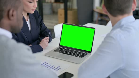 Rear View of Male and Female Business Person Using Laptop with Green Chroma Screen