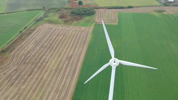 Slow panning shot above wind turbine in British countryside