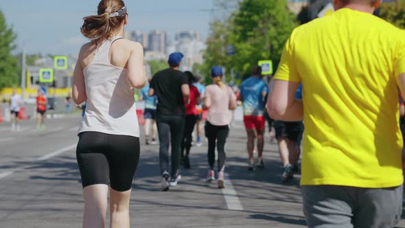 Slow Motion Woman Running Marathon in City