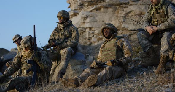 Soldiers Sitting During a Break in an Assault alt