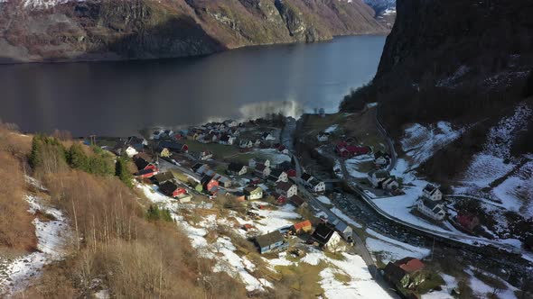 Looking down hillside at vi small remote village Undredal by the sea - Aerial Norway at winter sunri