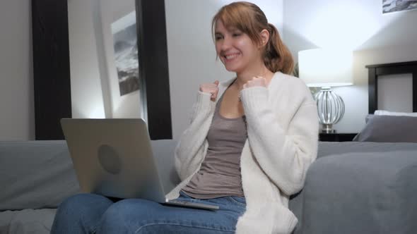 Woman Excited for Success, Working on Laptop