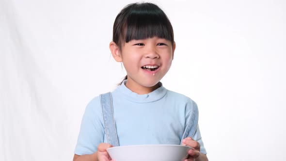 Cute little girl having breakfast.