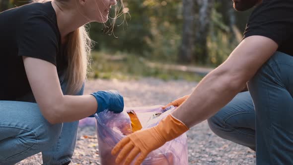 Two Volunteers Picking Up Trash and Rubbish in Their Community Park Not To Far From Their Home