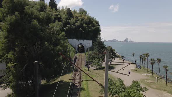 Aerial view of Georgian railway high speed train moving near the sea in Batumi. Georgia 2021