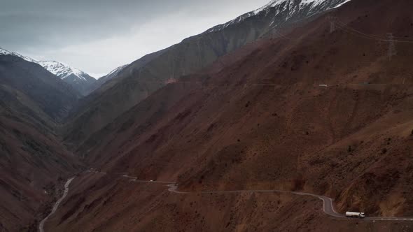 Aerial of View Mountain Landscape with Huge Rocky Mountains and Serpentine Roads on Which Cars