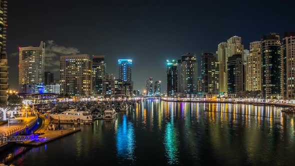 View of Dubai Marina Towers and Yahct in Dubai at Night Timelapse Hyperlapse