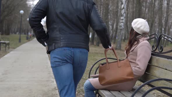 Robber Carries the Woman's Bag Off the Bench in the Park