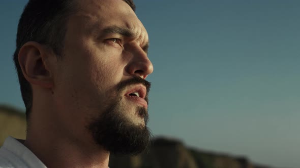 Thoughtful Sportsman Face Watching Sunset on Beach