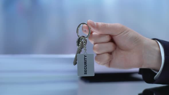Security Written on Keychain Male Demonstrating and Lying on Table, Secrecy
