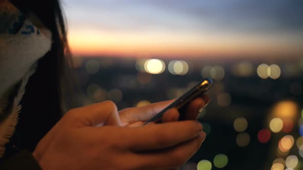 Steadicam Close-up on Woman Hands Using Smartphone Mobile Office at Beautiful Bokeh Sunset City