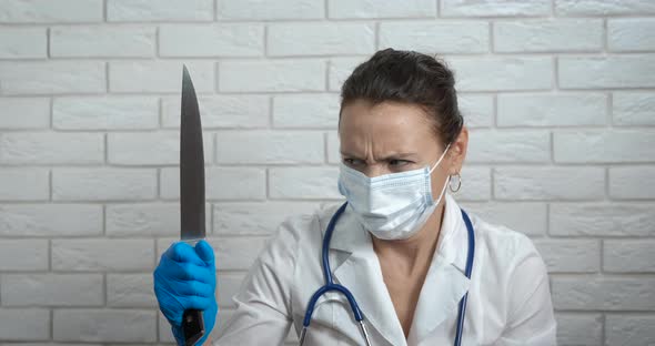 Doctor Looking at Knife