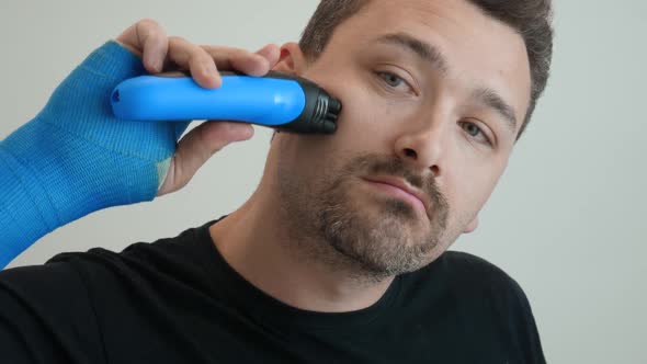 Man Shaves His Cheek