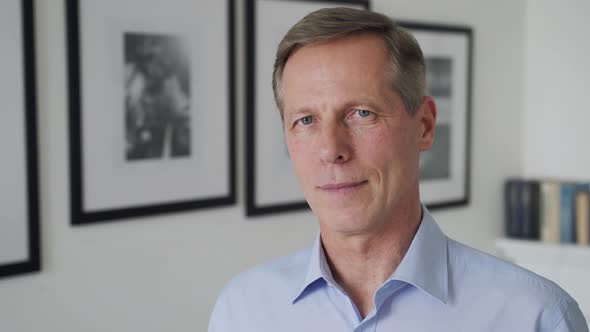 Confident Mature 60s Man Looking at Camera at Home Portrait