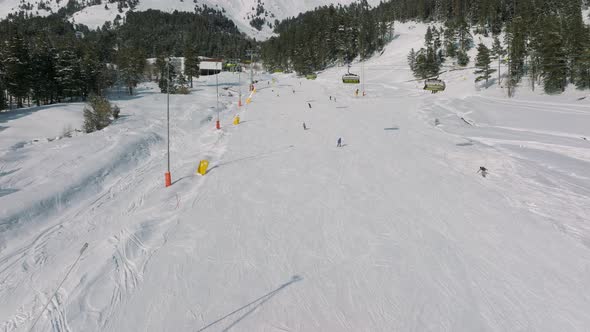 Aerial View of a Ski Resort with People Snowboarding and Skiing From a Hill