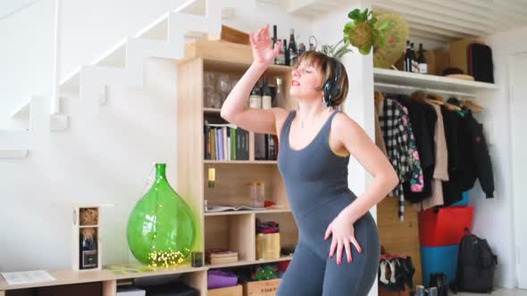 adult woman indoor listening music dancing and screaming