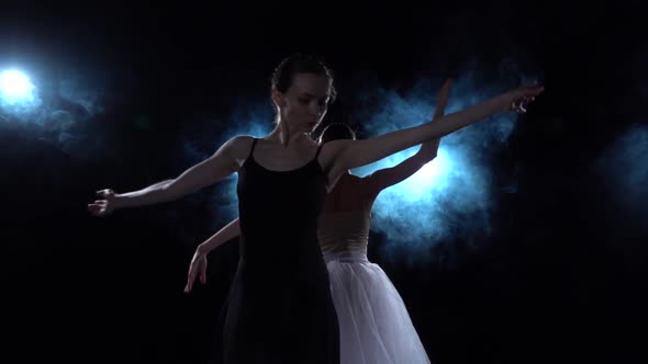 Tender Ballerinas in White and Black Tutu Spinning in Dance, Close Up, Slow Motion