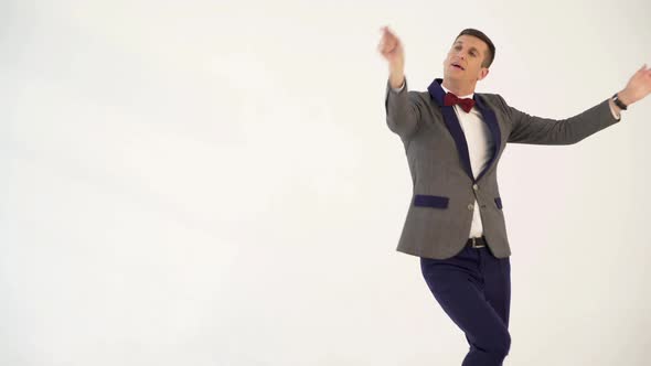 Humorist in Gray Suit with Red Bow Tie is Dancing in the Similitude of Dancer 