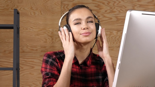 Young beautiful woman listening to music with headphones