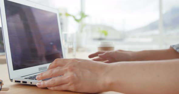 Businesswoman working over laptop at her desk