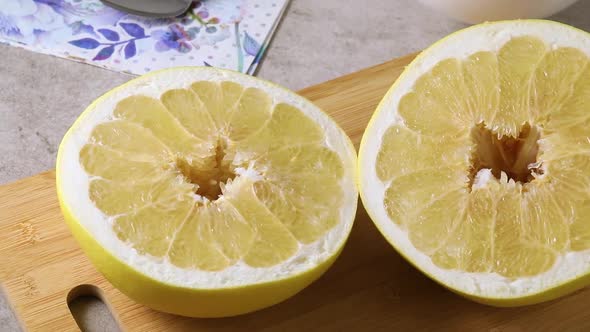 Halved fresh large yellow pomelo close up 