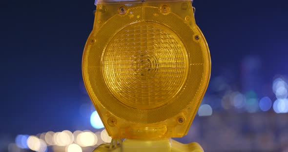 Yellow road construction warning light at night