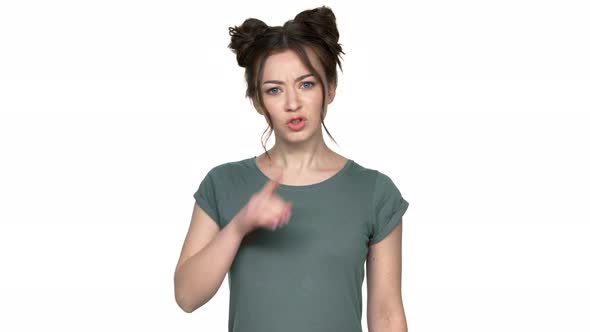 Portrait of Woman with Double Buns Hairstyle Looking on Camera with Strict Gaze and Asking to Keep