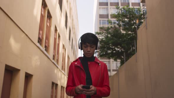 Transgender adult listening to music in the street