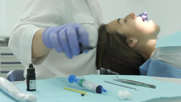 Tilt up of a dentist treating a patient