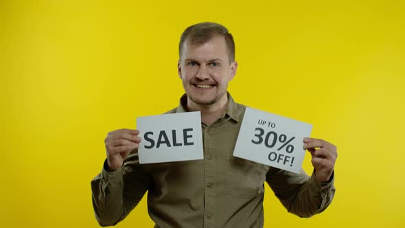 Attractive Man Showing Sale Word and Showing Up To 30 Percent Off Inscription. Black Friday Concept