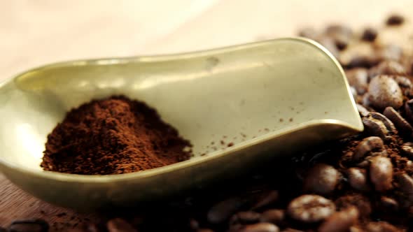 Coffee beans with powder and scoop