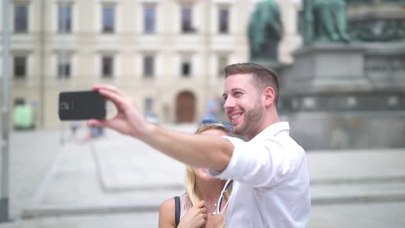 Happy Tourist Couple Taking Selfie in City