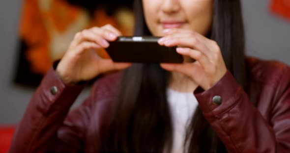 Woman taking photo of meal with mobile phone 4k