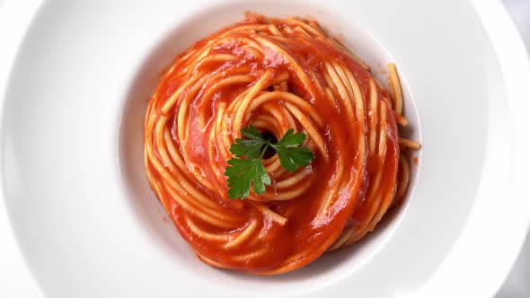 Top View of Vegetarian Spaghetti with Tomato Sauce in White Plate