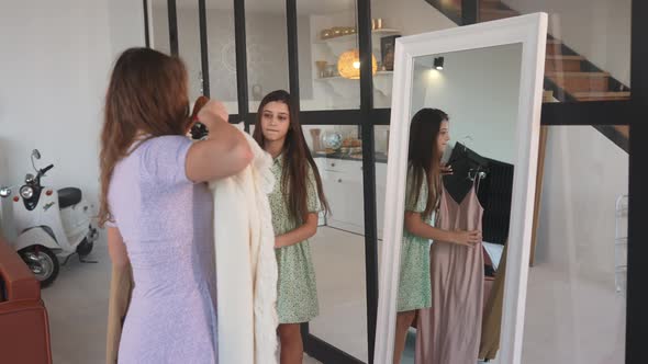 Two Women Choose and Try on Clothes at Home