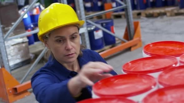 Female Worker Checking Inventory in Warehouse