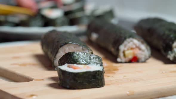 The Chef Lays Down Sets for Delivery Pieces of Sushi and Roll Made From Seafood with Asian