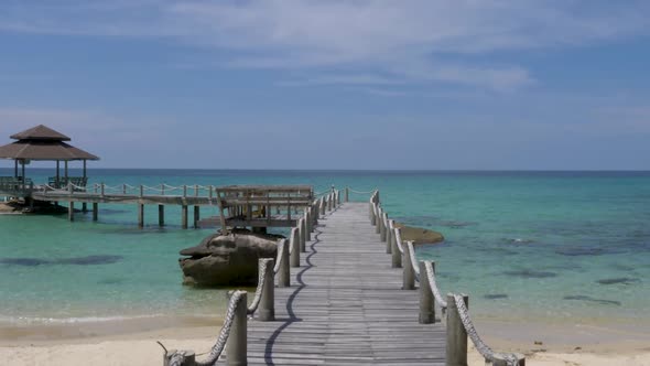 POV Walking on wooden footbridge that leads to the sea. Koh Kood, Thailand. SLOW MOTION