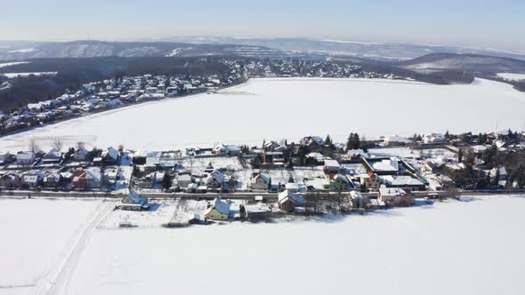 Aerial Drone Shot  Snowcovered Villages Fields and Forests in a Rural Area in Winter