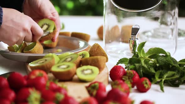 Time lapse. Step by step. Slicing fresh organic kiwi for infused water