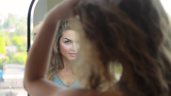 Beautiful Woman Looking to the Mirror and Admire Herself