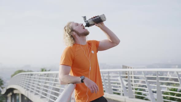 Sporty Caucasian man drinking water