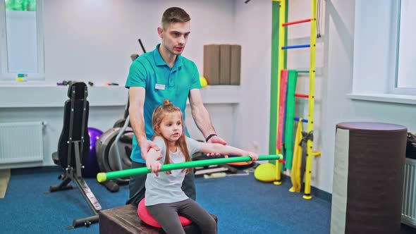 Young Girl Doing Exercises Under Physiotherapist Supervision alt