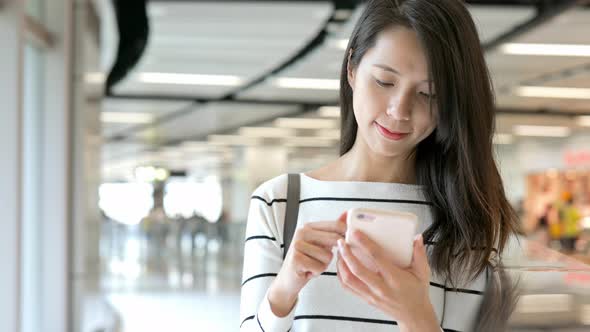 Woman Use of Mobile Phone at Train Station