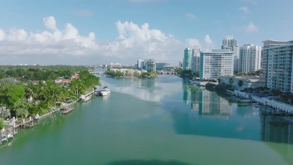 Sunny Day in Town Forwards Fly Above Water Surface Lined By Modern Multistorey Residential Buildings